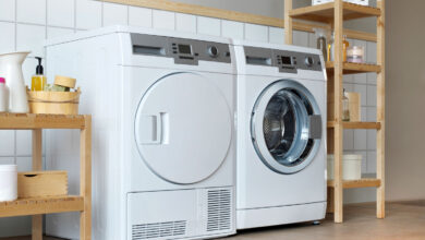 Two white duet dryers inside a laundry room